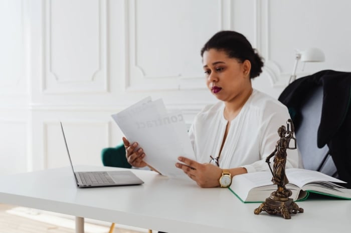 Woman reviewing contacts at her desk