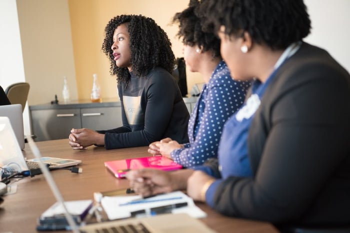 three women in a meeting